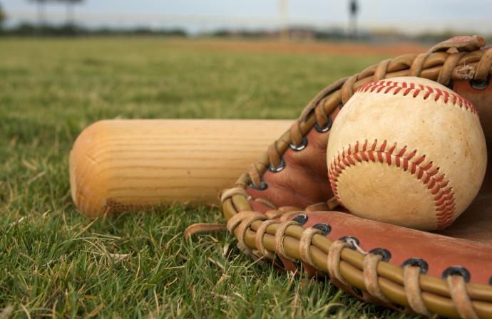 Picture of a glove with a baseball and a bat. 